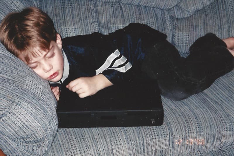 Anthony Custable as a child sleeping with a laptop